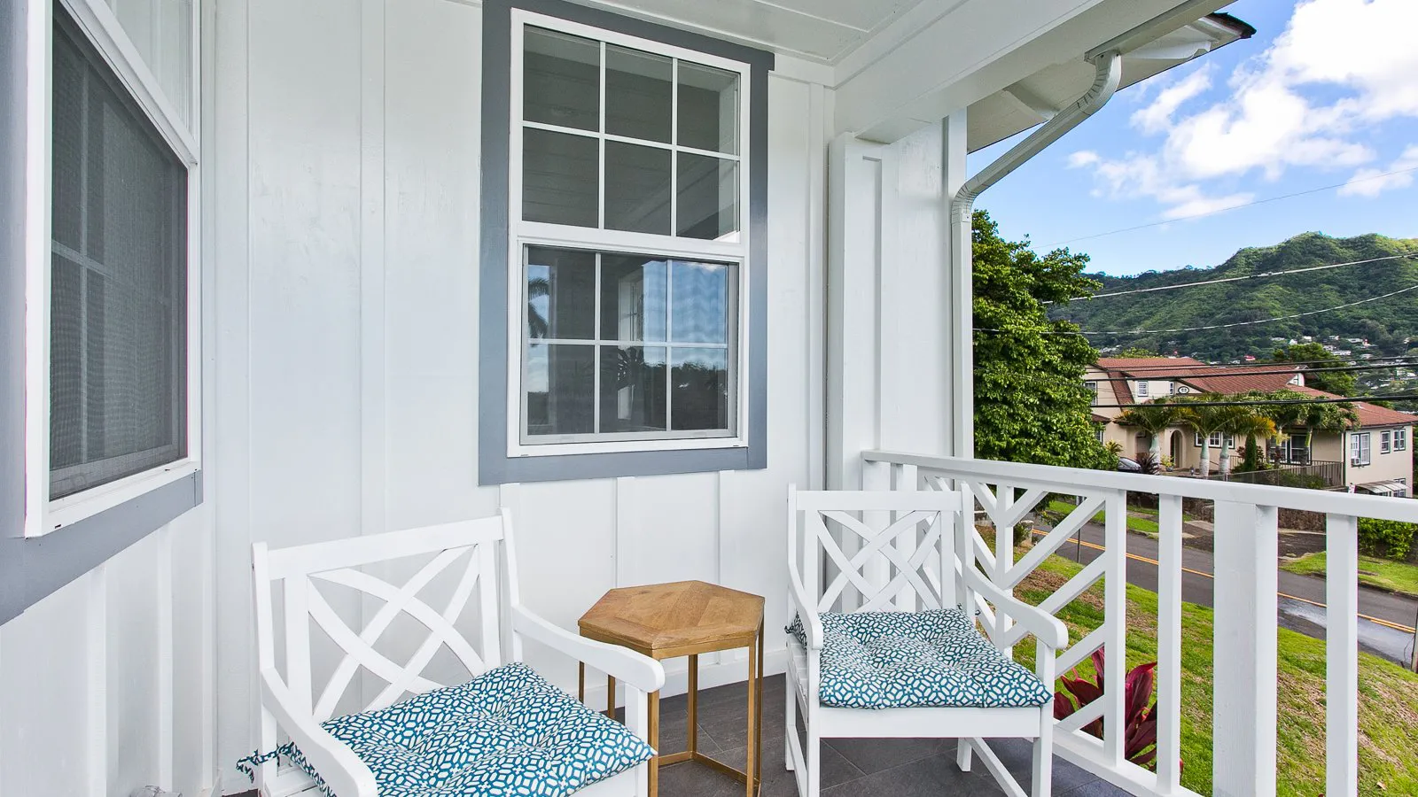 Front lanai with chairs looking out over Manoa Valley rooftops and ridges