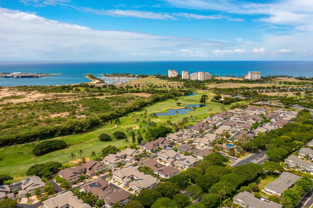 Aerial view of West Oʻahu coastline, golf course, and homes