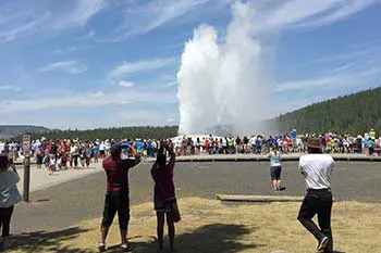 People watching the Old Faithful geyser in Yellowstone