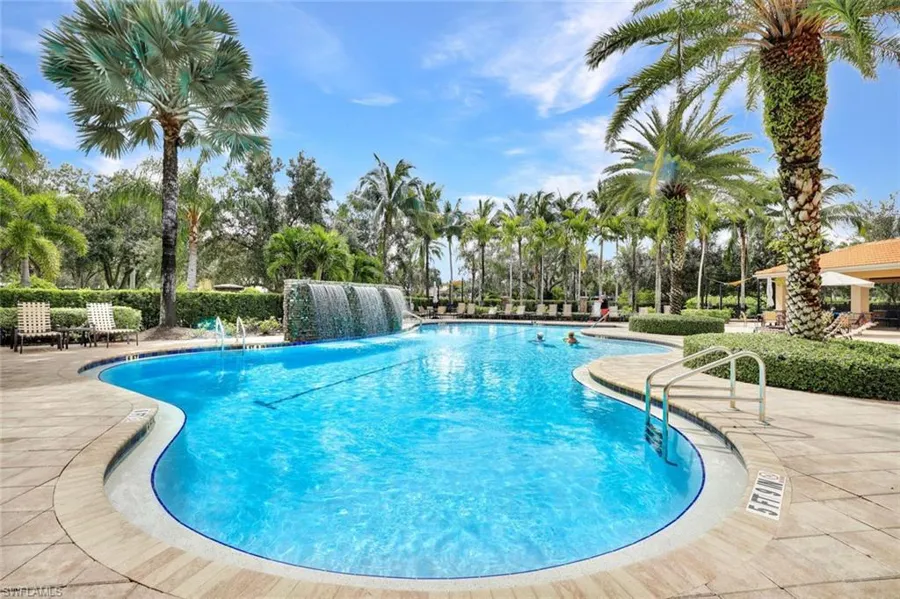 Resort style pool with waterfalls and palm trees in a Bonita Springs luxury community