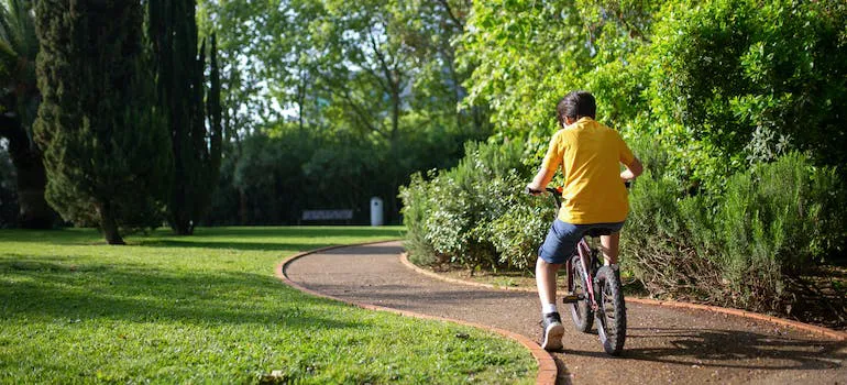 A boy riding a bike in a park.