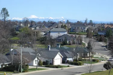 Street scene of Gold Hills subdivision, Redding CA with homes & mountains