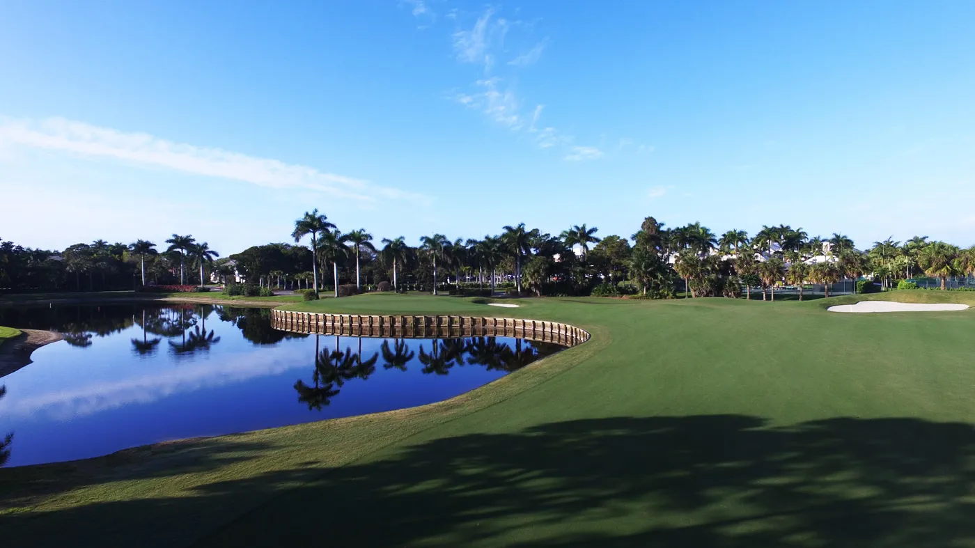 Exclusive golf course with palm trees and lake views in a Bonita Springs luxury community