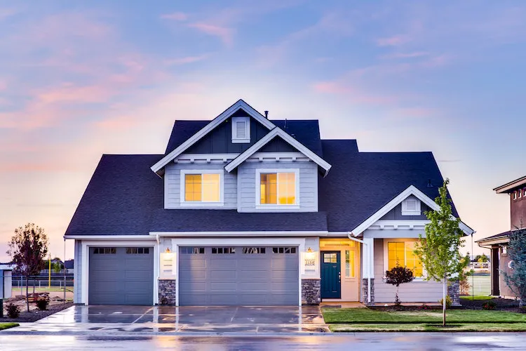 A big home with white garage doors