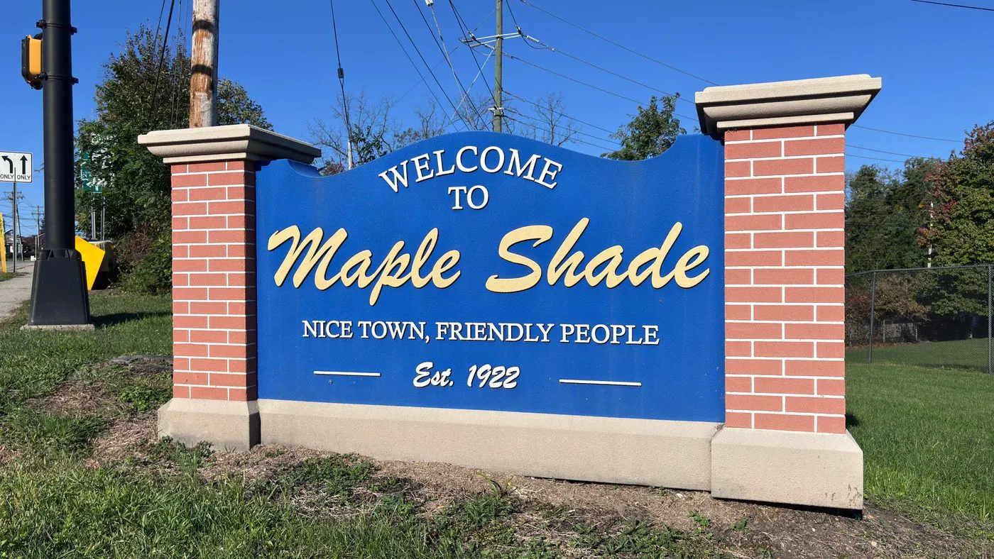 Welcome to Maple Shade sign reading Nice Town, Friendly People, Est. 1922, with brick pillars