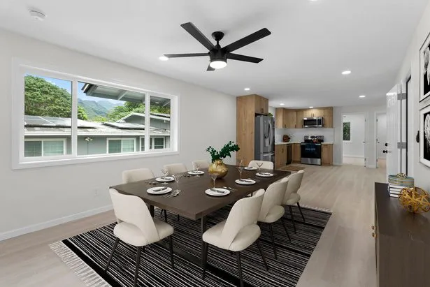 The same Oʻahu living and dining room after virtual staging with a dining table and rug
