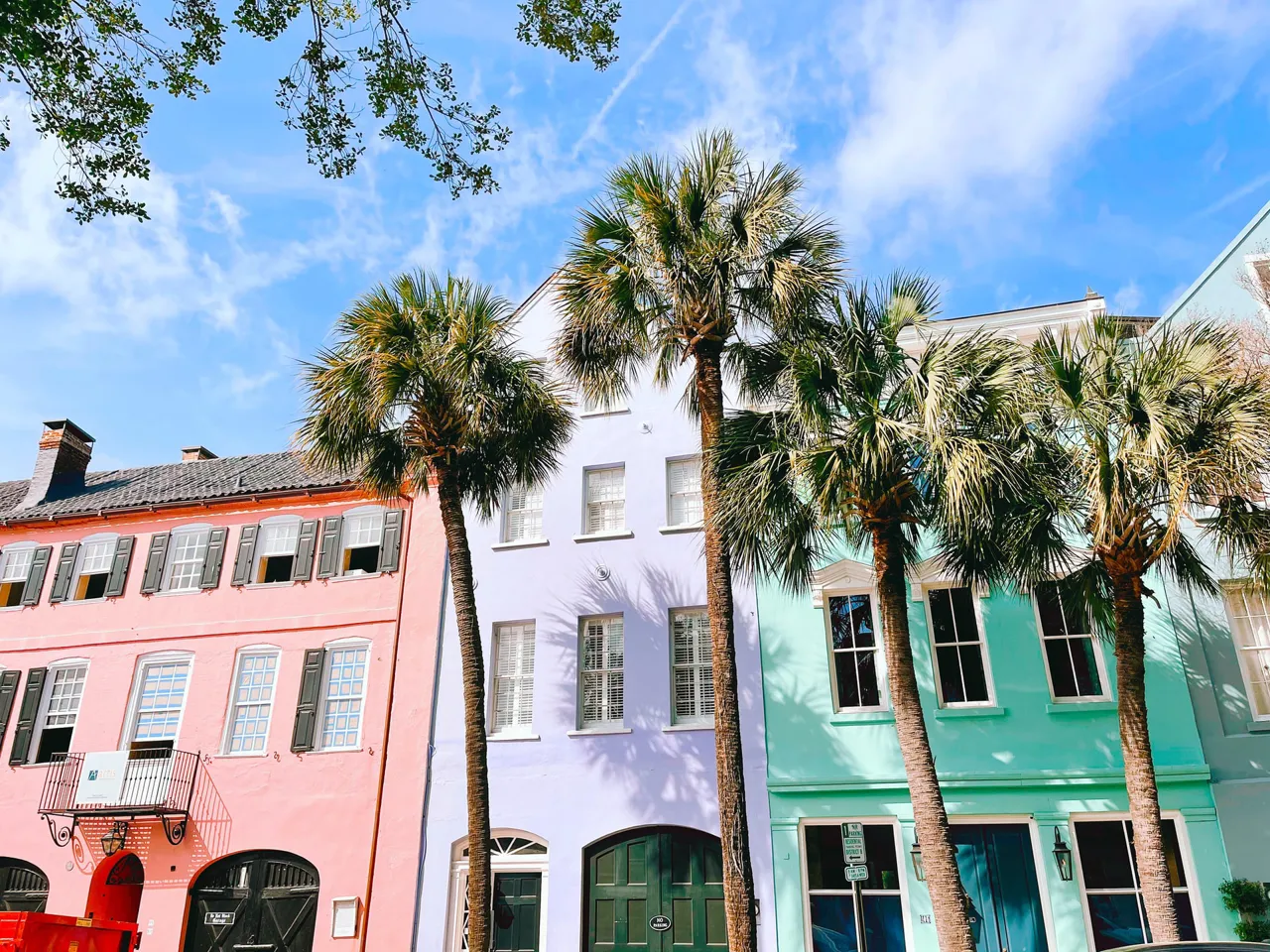A row of houses with palm trees in Charleston, South Carolina.