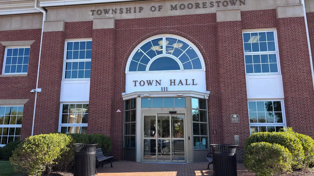 Moorestown Town Hall, a red brick building with a rounded window over the entrance